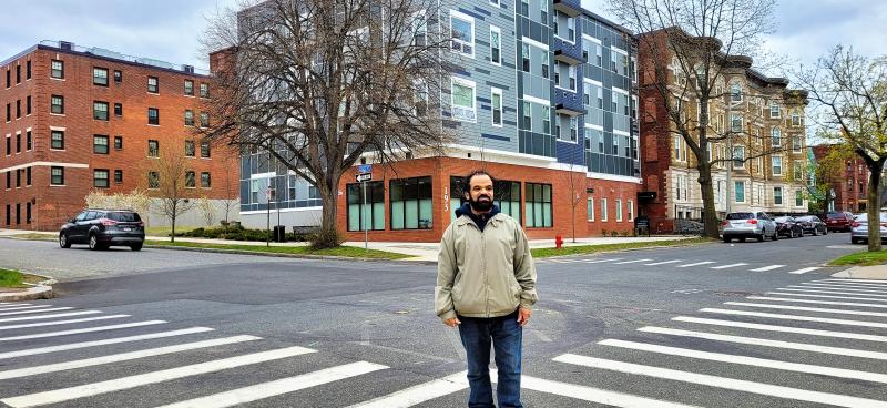 Gerardo Torres stands in front of Library Commons, Holyoke